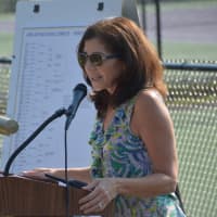 <p>Marianne Flayhan, former president of the John Jay Boosters Club, speaks at the dedication of the John Jay tennis courts.</p>