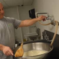 <p>Mike Grisafe readies the water for mozzarella-making in his Fair Lawn kitchen.</p>