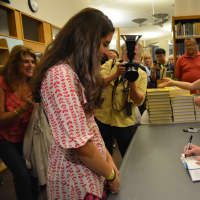 <p>Chelsea Clinton signs a copy of her new book, &quot;It&#x27;s Your World,&quot; for Chappaqua resident Amanda Cronin.</p>