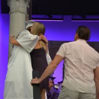 <p>The mother of Brian Conway, a deceased classmate who would have joined John Jay High School&#x27;s Class of 2016, receives a hug at the commencement.</p>