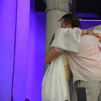 <p>The father of Brian Conway, a deceased classmate who would have joined John Jay High School&#x27;s Class of 2016, receives a hug at the commencement.</p>