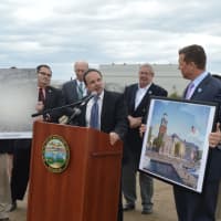 <p>Bridgeport Mayor Joe Ganim showed a photo of the Steelpointe Harbor area when I-95 was being built, left, and an artist&#x27;s rendering of work to be completed there by 2018.</p>