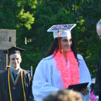 <p>A happy graduate gets her diploma at the Shelton High graduation.</p>