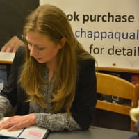 <p>Chelsea Clinton signs a copy of her new book, &quot;It&#x27;s Your World,&quot; at the Chappaqua Library.</p>