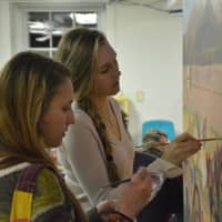 <p>Left to right: Sita Watanabe and Morgan Katsch work on a new mural in the children&#x27;s studio at the Katonah Art Center&#x27;s new home in Goldens Bridge.</p>
