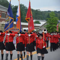 <p>A color guard of band marchers joins the Mahopac Volunteer Fire Department&#x27;s dress parade.</p>
