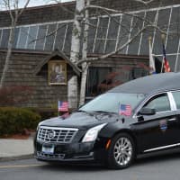 <p>A hearse containing the casket of Putnam County Undersheriff Peter Convery prepares to leave the grounds of a Mahopac church following a funeral.</p>