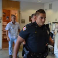 <p>Hengjun Chao, the suspect in Monday&#x27;s shooting at Lange&#x27;s deli in Chappaqua, is escorted by New Castle Police to his arraignment.</p>