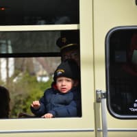 <p>A child looks out of the window of a Mount Kisco firetruck during the St. Patrick&#x27;s Day parade.</p>