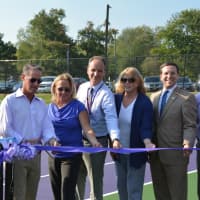 <p>Community members, including Katonah-Lewisboro officials and elected officials, pose for photos at a ribbon-cutting ceremony or the John Jay tennis courts.</p>