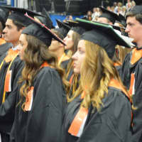 <p>Stundents line up in black and orange for the Ridgefield High graduation Friday at Western Connecticut State University.</p>