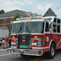 <p>A Mahopac firetruck is driven through the fire department&#x27;s dress parade.</p>