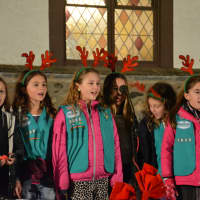 <p>Girls Scouts from Katonah&#x27;s Troop 1038 sing at the tree and menorah lighting celebration.</p>