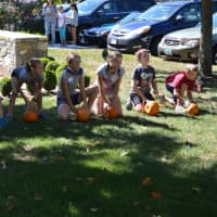 <p>Kids line up for a pumpkin-rolling contest in Easton.</p>