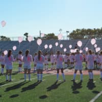 <p>The athletes formed a ribbon on the field before...</p>