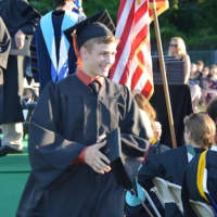 <p>A happy graduate gets his diploma at the Shelton High graduation.</p>