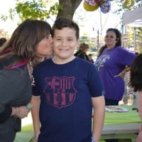 <p>Pet ResQ Founder Robyn Urman shows love to Jon McKiernan, 12, of Harrington Park, who hopes his $80 donation will help orphaned dogs find homes. </p>