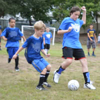 <p>Athletes scrimmage against each other during the Angels Soccer 2015 kick off program.</p>