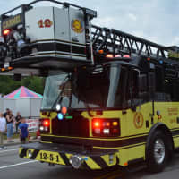 <p>A yellow Carmel firetruck is driven at the Mahopac Volunteer Fire Department&#x27;s dress parade.</p>