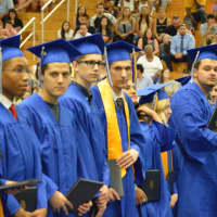 <p>Students receive their diplomas at the Abbott Tech High School graduation.</p>