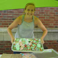 <p>Grace Sangercox from La Dolce Vita in Newtown serving up fun summer styled cookies for the farmers market in Newtown&#x27;s Farmers market in Fairfield Hills.</p>