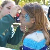 <p>Face painters glamify supporters at Woofstock.</p>