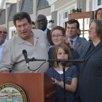 <p>Owner Lou Montanari, at podium, is joined by his children Michael and Mia, and his wife and co-owner, Jennifer, right, and Mayor Joe Ganim, left, as he officially opens Hub and Spoke in Bridgeport.</p>