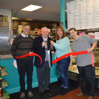 <p>Fairfield First Selectman Michael Tetreau, second from left, and owner Alicia Connelly, second from right, cut the ribbon on her business, D. Lish &amp; Co. in Fairfield.</p>