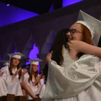 <p>A John Jay High School 2016 graduate gets a hug following a performance by The Notables, which is an all-girls student a cappella group.</p>