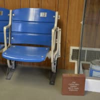 <p>Mets memorabilia is visible in the front lobby of Mt. Kisco Glass. Pictured as a pair of seats from Shea Stadium and a replica donation brick of one displayed by Citi Field.</p>