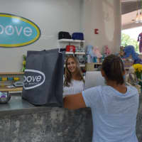 <p>Corri Neckritz checks out a customer at Groove of Westport.</p>