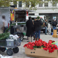 <p>Extras bundled up against winter chill waited for the filming to begin at McLevy Green Tuesday.</p>