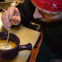 <p>Araya puts the finishing touches on butternut squash soup.</p>