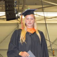 <p>A Ridgefield High graduate gets her diploma</p>