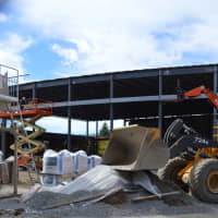 <p>Construction crews work on the new music classrooms on the site of the former auditorium at Greenwich High School Friday.</p>