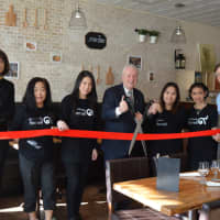 <p>Fairfield First Selectman, fourth from left, and Thai Kit co-ownr Nattima Sonsoem, third from right, cut the ribbon at the grand opening of the Fairfield eatery.</p>