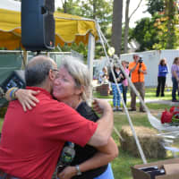 <p>Jamie Love&#x27;s mother, Michelle, gets a hug from Neal Schwartz, president of the Armonk Chamber of Commerce. A 5K held on Sunday is named in honor of Jamie Love.</p>