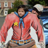 <p>Trying on a cowboy suit for size at the 7th annual Country Fair at the Easton Public Library.</p>