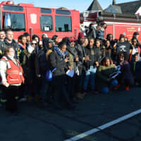 <p>American Red Cross members along with Bridgeport firefighters and University students gather together for a photo opportunity before getting on their buses to various locations to volunteer their time.</p>
