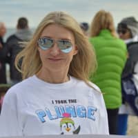 <p>Jill Fraser of Stamford is one of the many swimmers that took a plunge into Long Island Sound in Greenwich Friday to celebrate the New Year.</p>