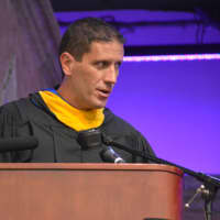 <p>John Jay High School teacher Thomas Rizzotti delivers the keynote speech at the 2016 commencement.</p>