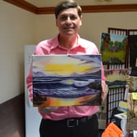 <p>Artist Patrick Marino has his paintings on display for sale at the Blueberry Festival.</p>