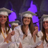 <p>A group of John Jay High School graduates offer a round of applause at the 2016 commencement.</p>