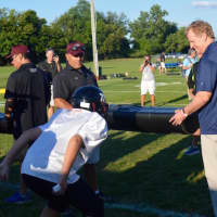 <p>NFL Commissioner Roger Goodell runs drills with players at a Fairfield Giants practice.</p>