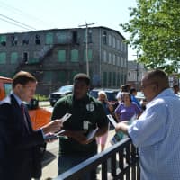 <p>U.S. Sen. Richard Blumenthal, left, and Jonathan James, center, a public health associate with the Bridgeport Health Department, share information on mosquito-borne illnesses with residents of the city&#x27;s Hollow neighborhood.</p>