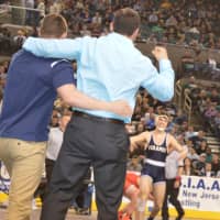 <p>Paramus coaches celebrate as Kyle Cochran comes out of the NJSIAA semifinal round victorious.</p>