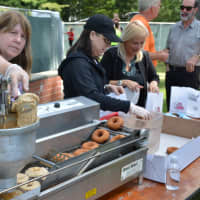 <p>Fresh donuts are prepared at the Armonk Fall Festival.</p>