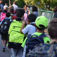 <p>Students file into Travell Elementary on the first day of school Wednesday.</p>
