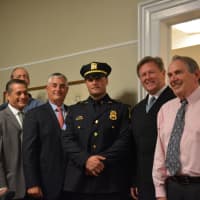 <p>Newly minted Police Chief Charles Beckett (left) and Police Sergeant David Alfano (center) pose for photos with members of the Lewisboro Town Board.</p>