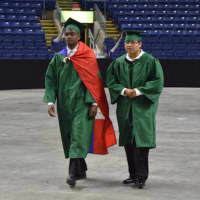 <p>The graduates march across the center of the Webster Bank Arena to start the Bassick High graduation.</p>
